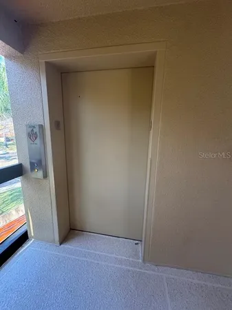 a view of an empty room and a window