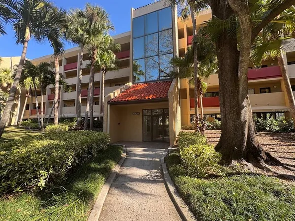 a front view of a multi story building with yard