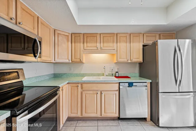 a kitchen with a sink stove top oven and microwave