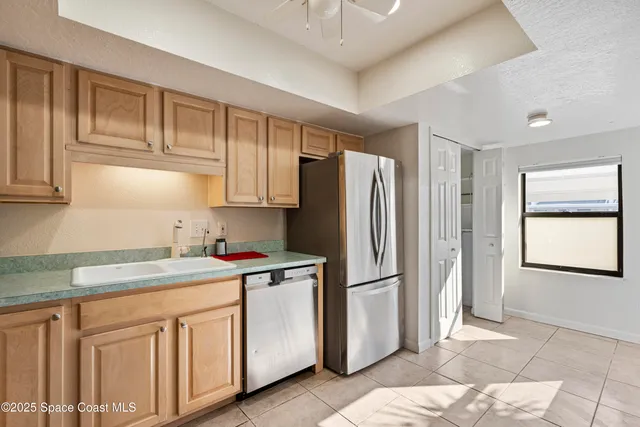 a kitchen with stainless steel appliances a refrigerator sink and microwave