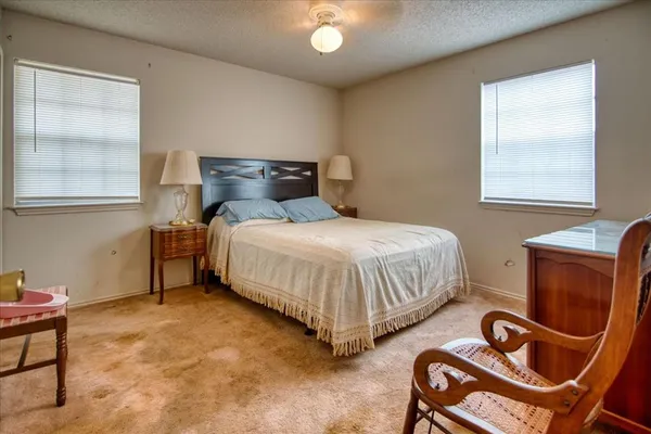 a bedroom with bed and a window