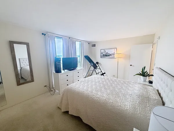 a bed room with a bed next to a window