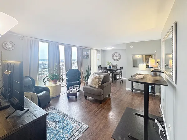a living room with furniture and wooden floor
