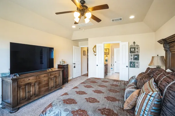 a bedroom with a bed and a flat screen tv