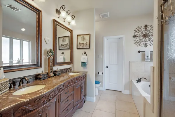 a spacious bathroom with a double vanity sink mirror and double