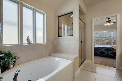 a bathroom with a tub shower and sink