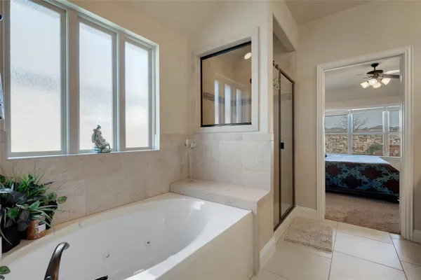 a bathroom with a tub shower and sink