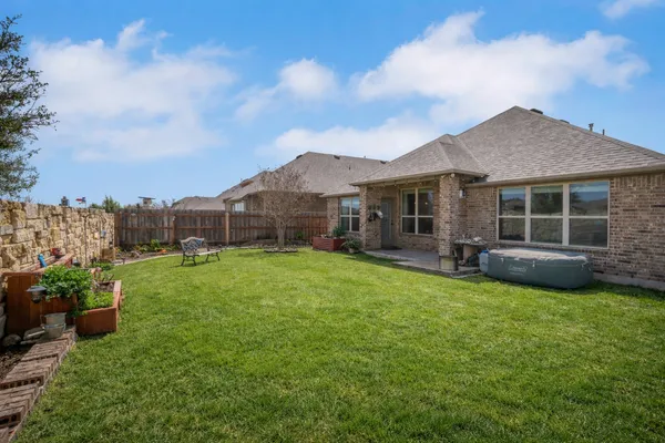 a view of a house with backyard sitting area and garden