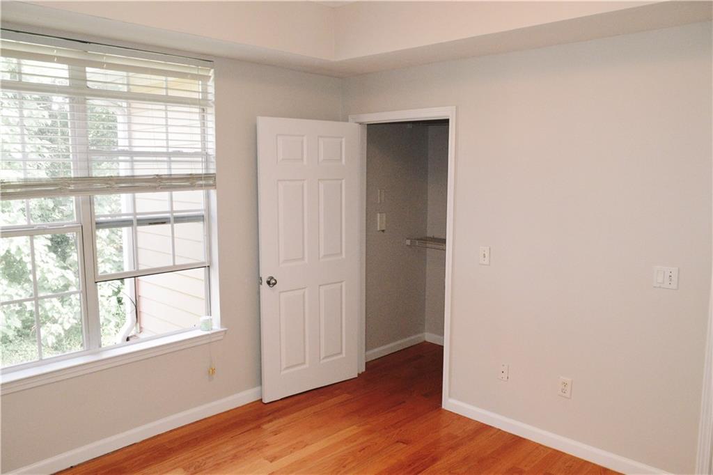 3500 Sweetwater Road, Unit 424 Duluth, GA 30096 - Photo 13 of 17 an empty room with wooden floor and windows