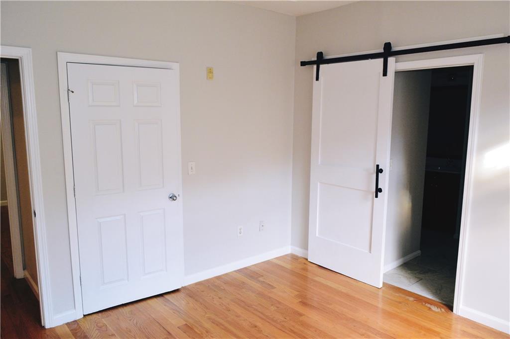 3500 Sweetwater Road, Unit 424 Duluth, GA 30096 - Photo 14 of 17 a view of an empty room with wooden floor and closet