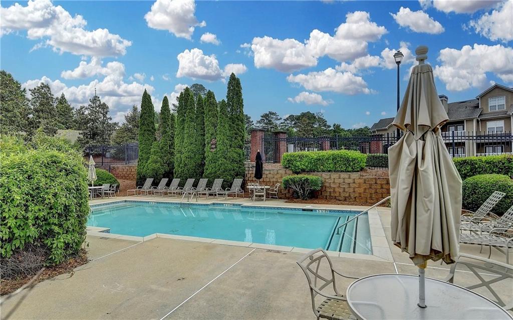 3500 Sweetwater Road, Unit 424 Duluth, GA 30096 - Photo 16 of 17 a view of a house with yard and swimming pool