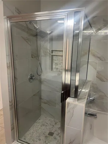 a bathroom with a glass shower door