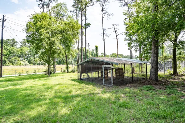 a front view of a house with a garden and trees