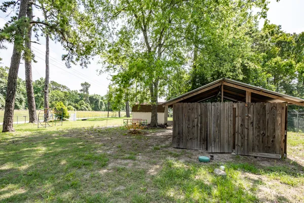a view of backyard of house with green space