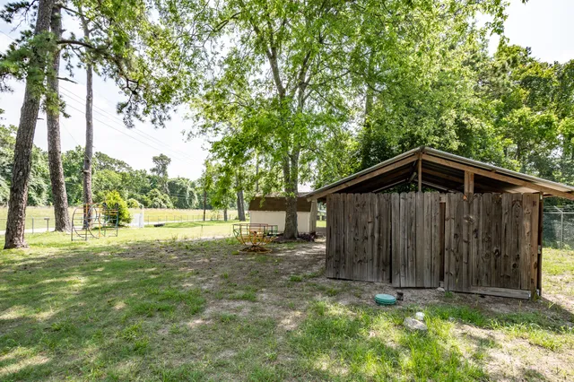 a view of backyard of house with green space