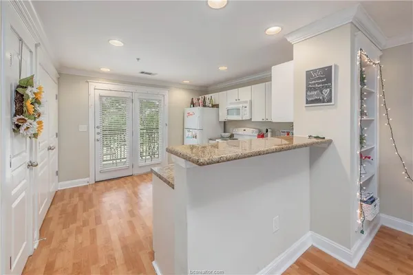 a kitchen with refrigerator and cabinets