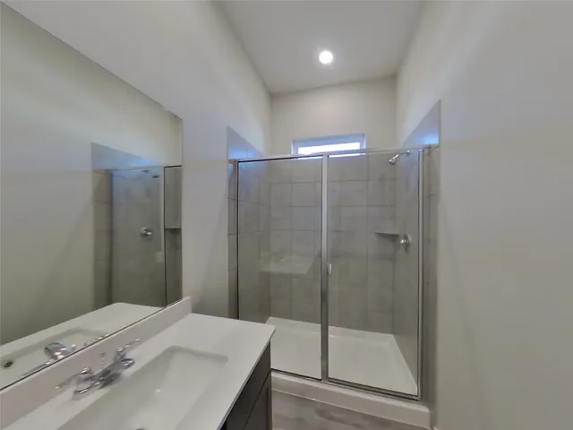 a bathroom with a shower and a sink
