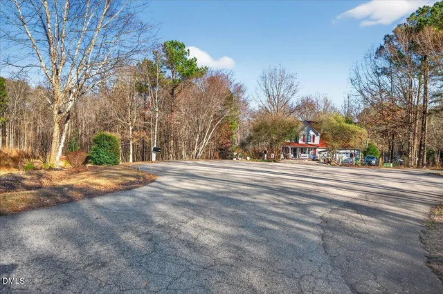 a backyard of a house with trampoline and trees