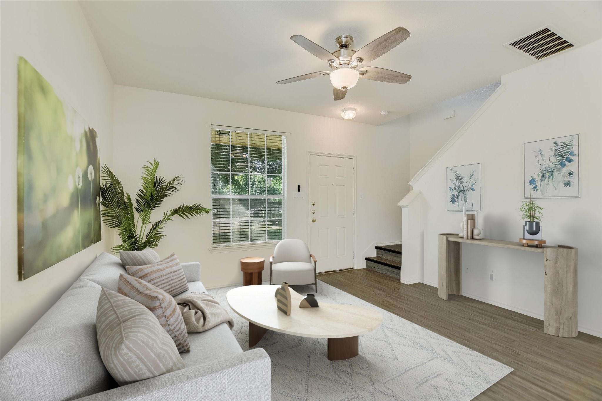 Living room with wood finished floors and ceiling fan *Virtually Staged*