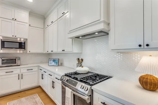 a kitchen with granite countertop a stove and a sink
