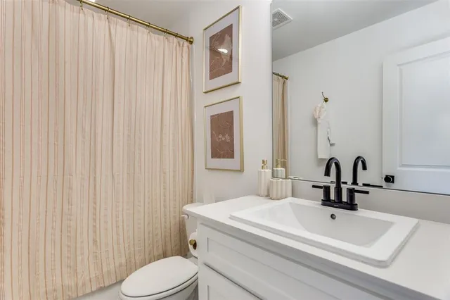 a bathroom with a sink a toilet and mirror
