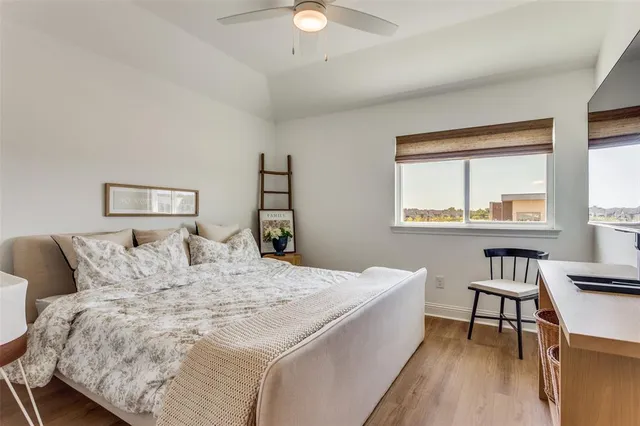 a bed sitting in a bedroom next to a window