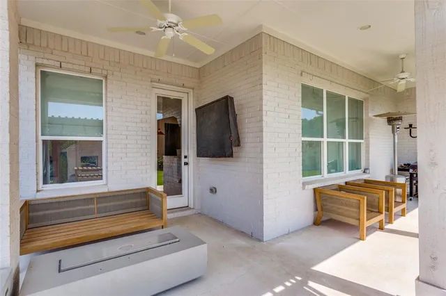 a backyard of a house with sofas table and sofas