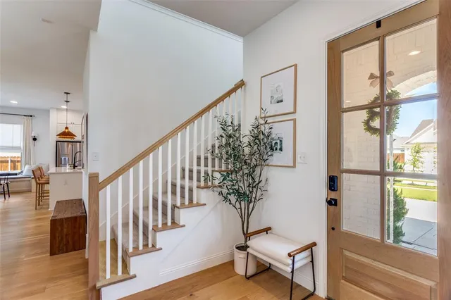a view of entryway with wooden floor and stairs