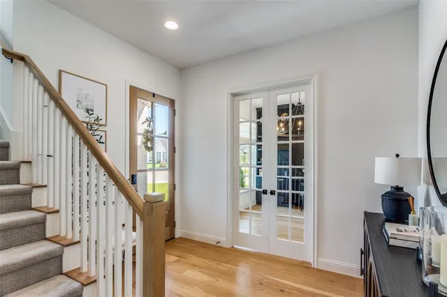 a view of an entryway with wooden floor and a livingroom