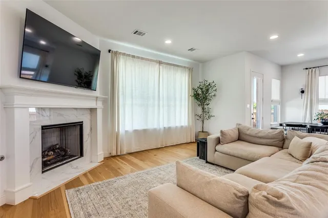 a living room with furniture fireplace and flat screen tv