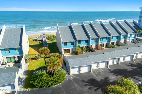 a view of a patio with table and chairs under an umbrella