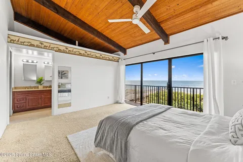 a view of a balcony with wooden floor and fence