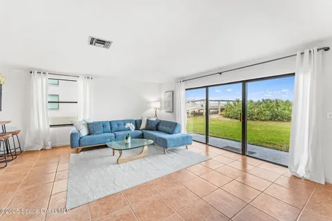 a living room with furniture and kitchen view