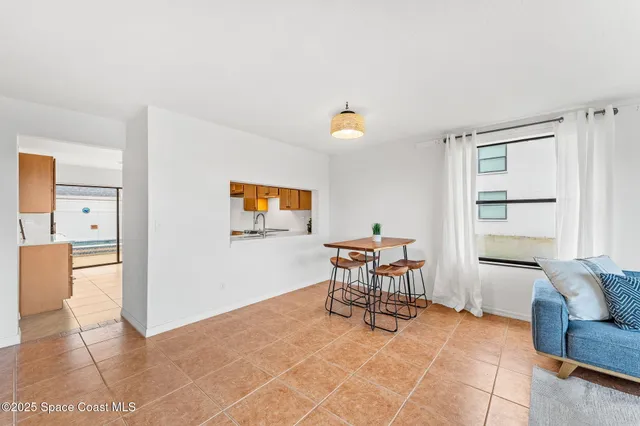 a kitchen with stainless steel appliances granite countertop a refrigerator a sink dishwasher a stove with white cabinets and wooden floor