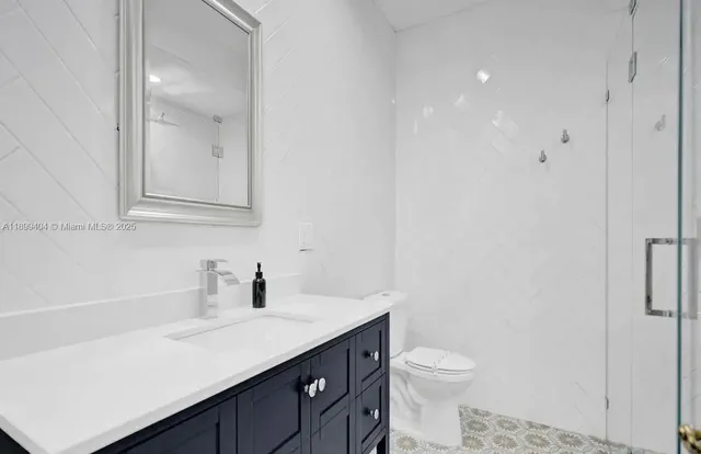 a room with pool table and windows