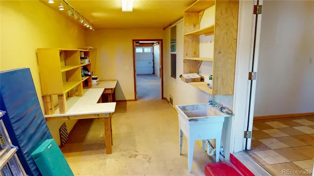 a view of a bedroom with wooden floor and ceiling fan