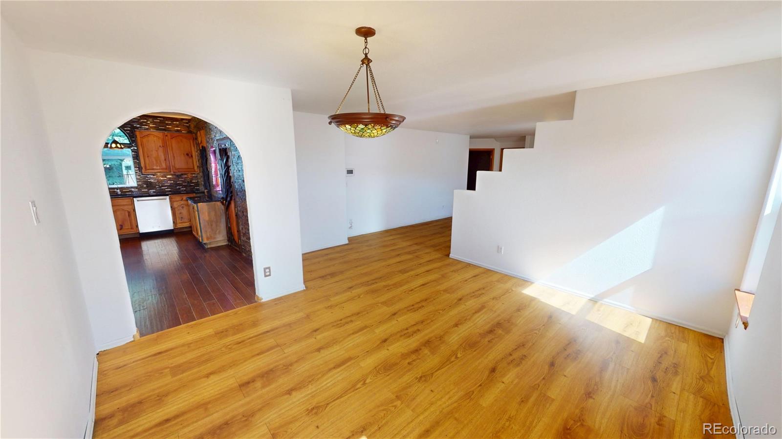 309 Main Street Romeo, CO 81148 - Photo 20 of 41 a view of a bedroom with wooden floor and ceiling fan