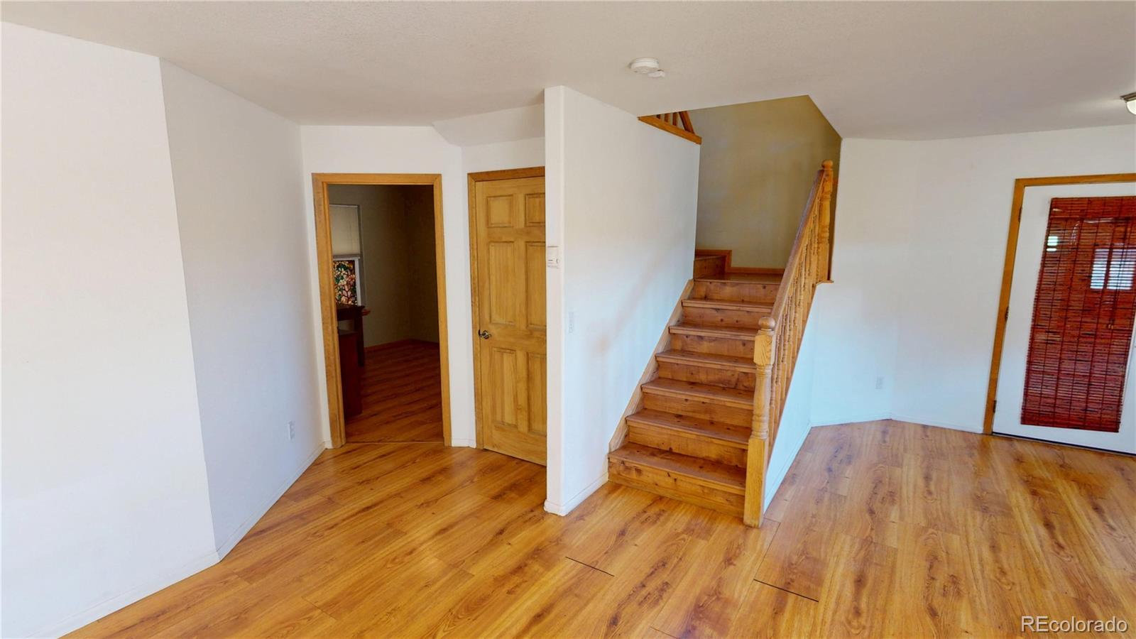 309 Main Street Romeo, CO 81148 - Photo 22 of 41 a view of a hallway with wooden floor and entryway