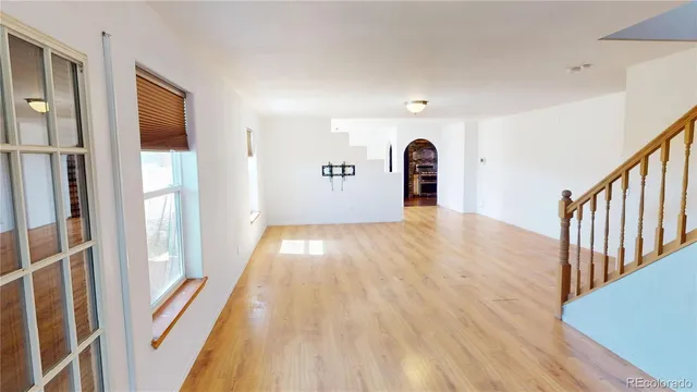 a workspace room with wooden floor and furniture