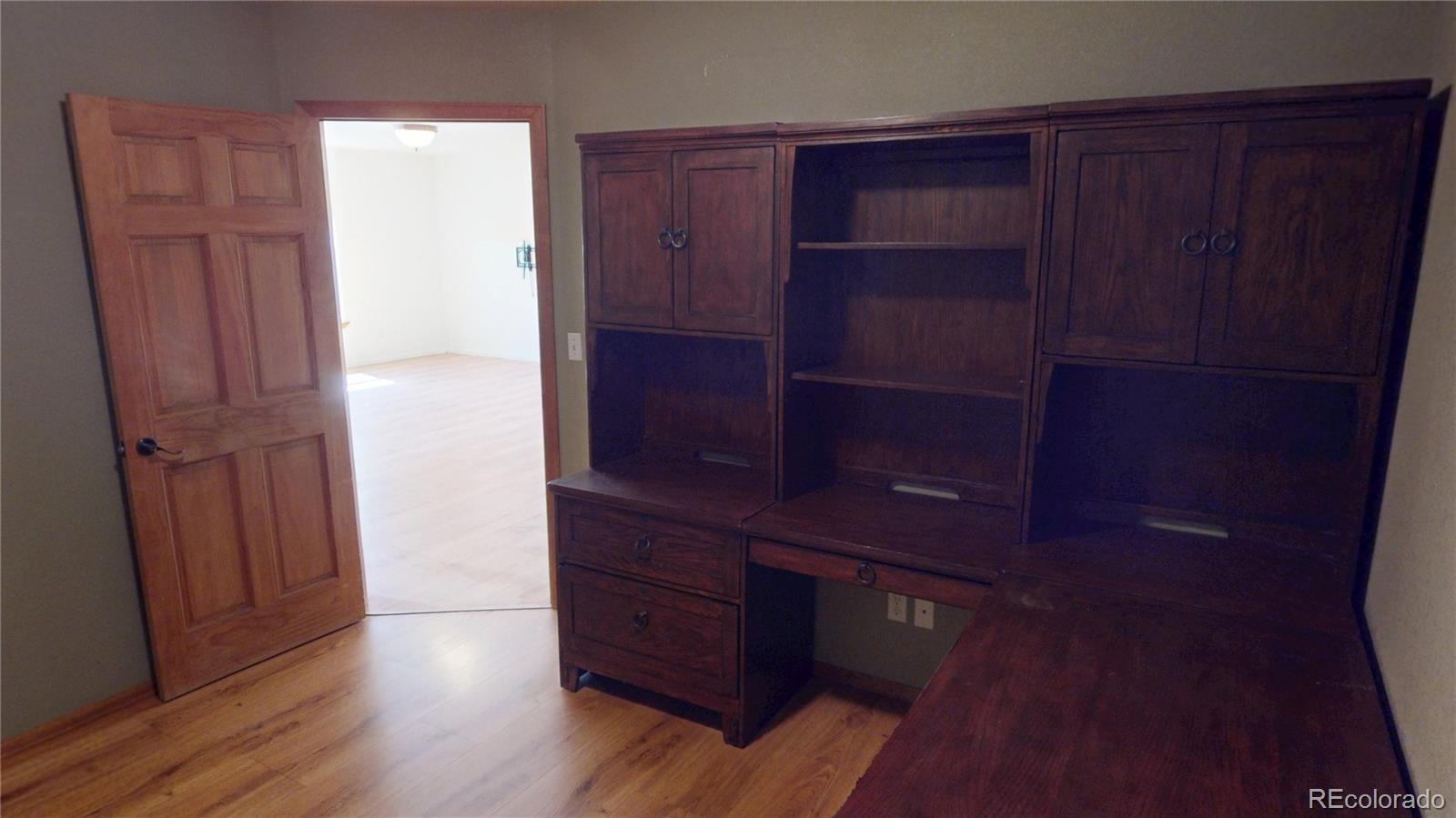 309 Main Street Romeo, CO 81148 - Photo 25 of 41 a room with wooden floor and cabinet