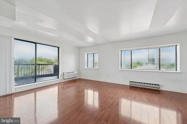 wooden floor in an empty room with a window