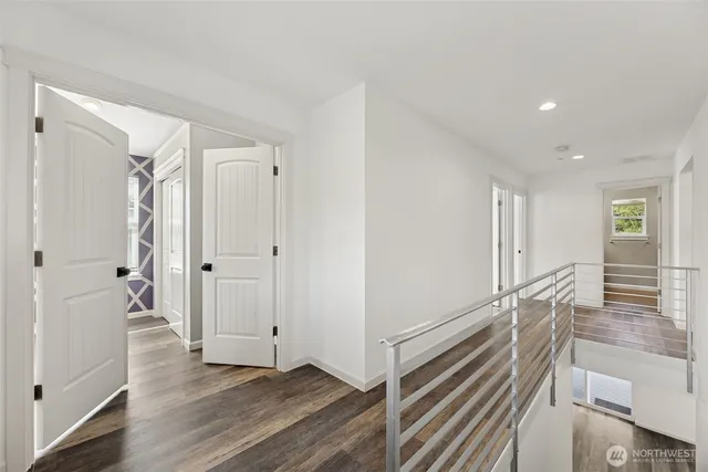 a view of a hallway with wooden floor