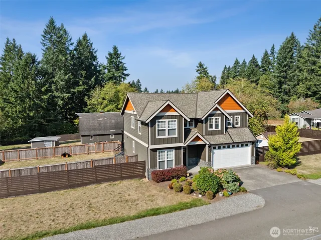 an aerial view of a house with a yard lake mountain view