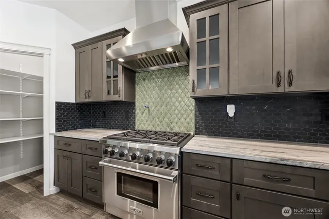 a kitchen with granite countertop a stove and a sink