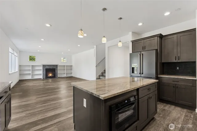 a kitchen with a sink appliances and cabinets