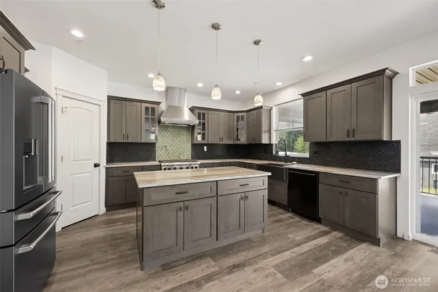 a kitchen with a sink stainless steel appliances and cabinets