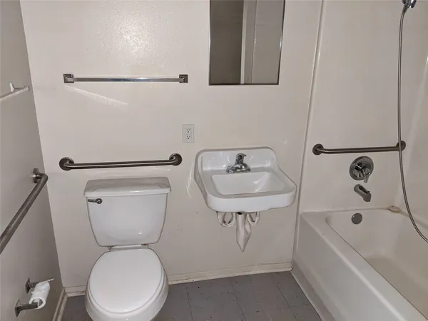 a bathroom with a toilet sink and bathtub