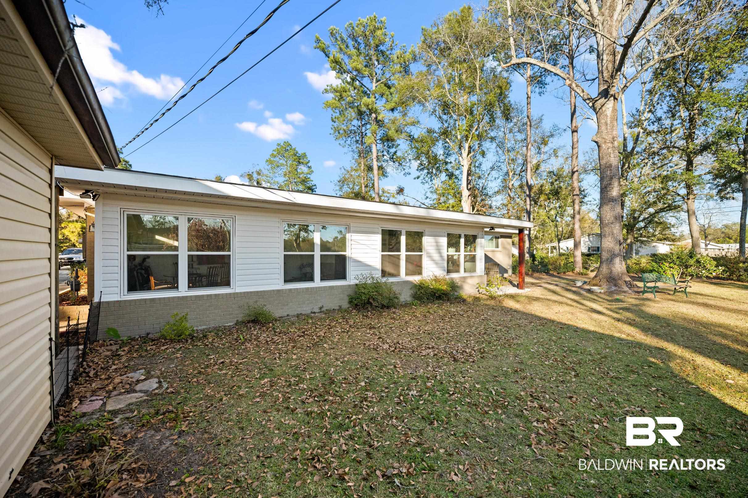401 West Myrtle Avenue Foley, AL 36535 - Photo 36 of 39 View of side of property featuring a lawn and brick siding