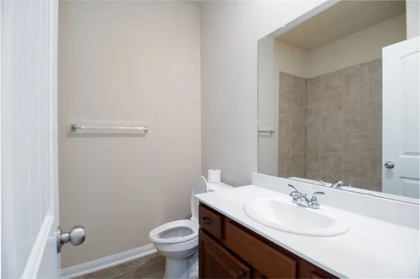 a bathroom with a sink toilet and a mirror