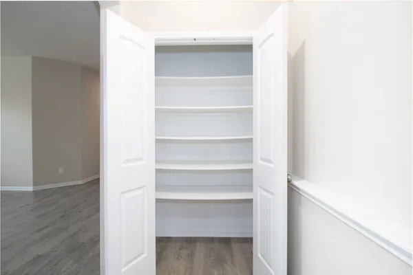 a view of walk in closet with empty racks